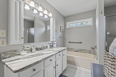 This spacious five-bedroom, four-bathroom raised beach home is