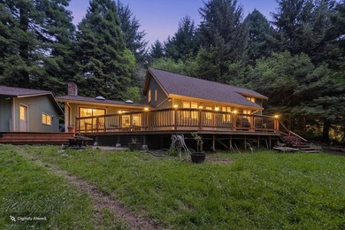 Perched among the trees on 3.24 private acres, this inviting - photo 3