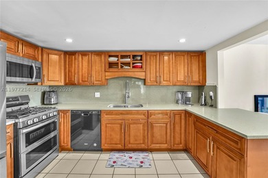 Tucked within the lush, gated community of Snapper Village, this - photo 11