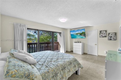 Tucked within the lush, gated community of Snapper Village, this - photo 16