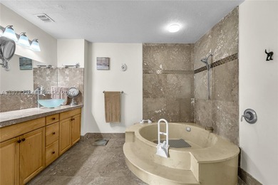 Tucked within the lush, gated community of Snapper Village, this - photo 18