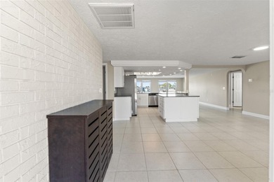 This beautifully updated Gulf Harbors waterfront home delivers