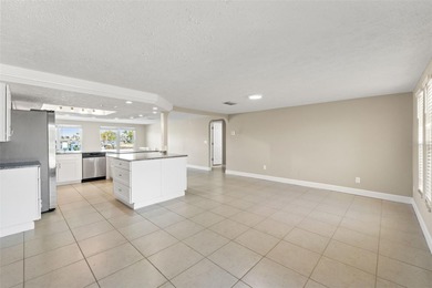 This beautifully updated Gulf Harbors waterfront home delivers