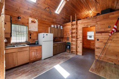 Tucked away on a private lot, this charming camp offers the - photo 3
