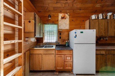 Tucked away on a private lot, this charming camp offers the - photo 4