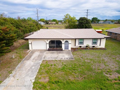 Tucked away in North Palm Bay, this cozy home offers the perfect - photo 2