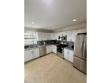 Welcome to this charming condominium located at 8785 SW 137th