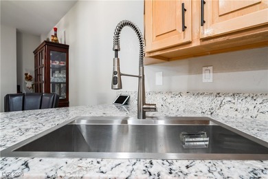 A rare single-story townhome in the gated Promenade at the