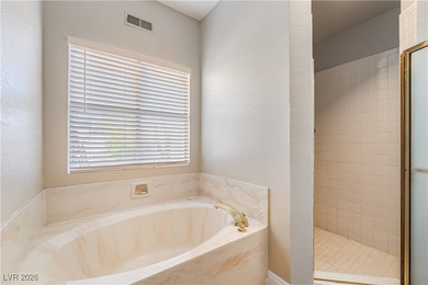 A rare single-story townhome in the gated Promenade at the