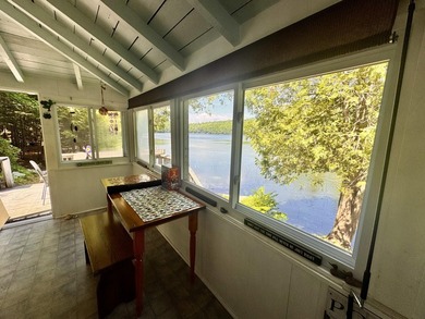 Tucked along the quiet shores of Hart Pond, this charming camp - photo 4