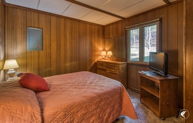 Nestled in a quiet wooded setting, this charming chalet-style - photo 12