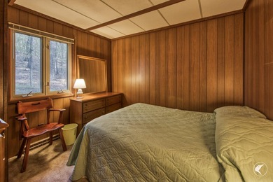 Nestled in a quiet wooded setting, this charming chalet-style - photo 13