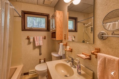 Nestled in a quiet wooded setting, this charming chalet-style - photo 14