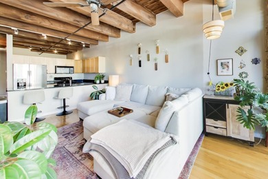 Step into this stunning brick-and-timber loft at the Premiere