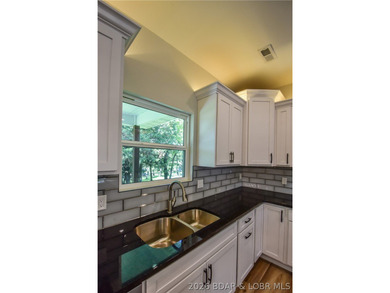 BRAND NEW HOME in the HEART of Osage Beach!! This striking home - photo 16