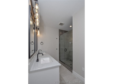 BRAND NEW HOME in the HEART of Osage Beach!! This striking home - photo 28