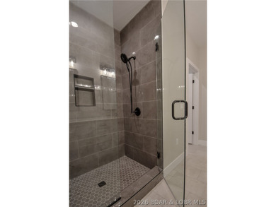 BRAND NEW HOME in the HEART of Osage Beach!! This striking home - photo 29