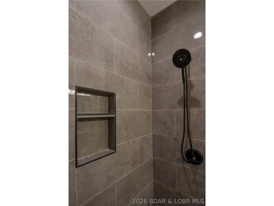 BRAND NEW HOME in the HEART of Osage Beach!! This striking home - photo 31