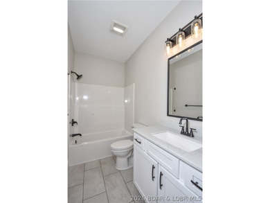 BRAND NEW HOME in the HEART of Osage Beach!! This striking home - photo 37