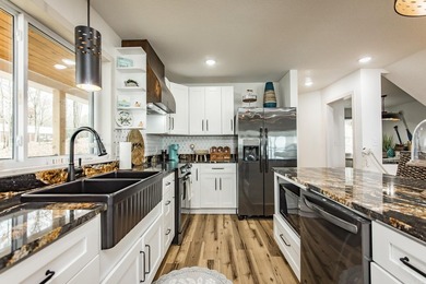This incredible LAKE HOME, just a little over a year old, offers - photo 12
