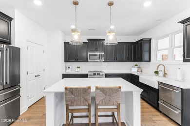 This beautifully appointed, premium end-unit townhome is like