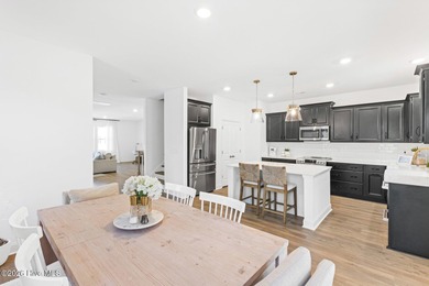 This beautifully appointed, premium end-unit townhome is like