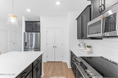 This beautifully appointed, premium end-unit townhome is like