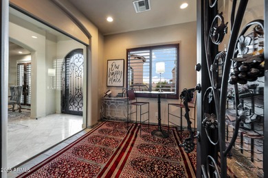 Positioned on an elevated, double-gated homesite within the