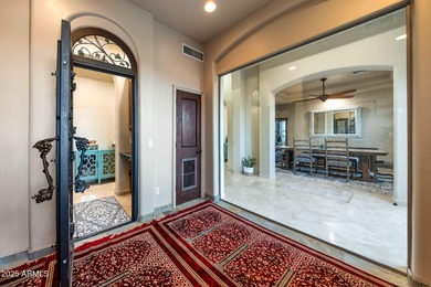 Positioned on an elevated, double-gated homesite within the