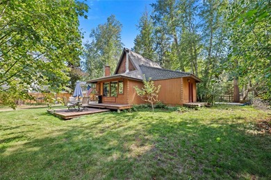 Nestled on a private, wooded .5-acre lot, this chalet-style home - photo 1