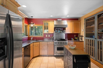 Nestled on a private, wooded .5-acre lot, this chalet-style home - photo 7