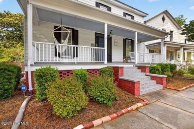 Step into the charm and character of downtown living in this - photo 2