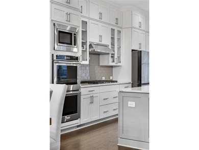 Experience elevated townhome living in the prestigious Gates at