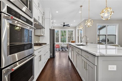 Experience elevated townhome living in the prestigious Gates at