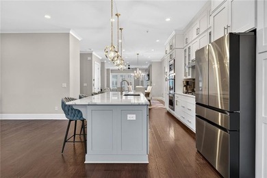 Experience elevated townhome living in the prestigious Gates at