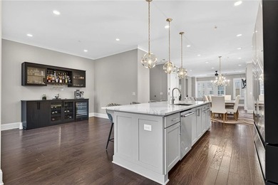 Experience elevated townhome living in the prestigious Gates at