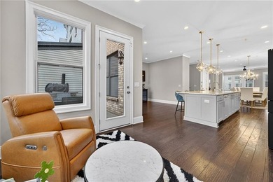 Experience elevated townhome living in the prestigious Gates at