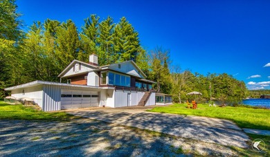 Set along the shoreline of Lower Saranac Lake within the - photo 12