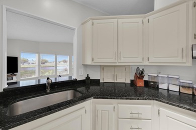 LAND OWNED 2/2 with rare 1 car garage! Nestled on a on a quiet - photo 20