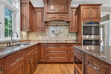 Nestled among mature trees and professionally landscaped grounds - photo 12
