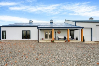 This exceptional 2-year-old barndominium offers modern country