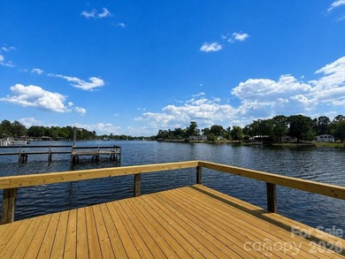 Nestled on a breathtaking 1.29-acre lakefront lot, this - photo 1