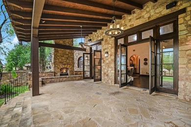 A front courtyard fireplace sets the tone, where the glow of the - photo 36