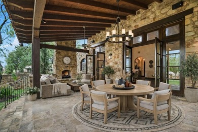 A front courtyard fireplace sets the tone, where the glow of the - photo 37