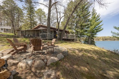 On the shores of beautiful Woman Lake, this home captures the - photo 1