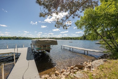 On the shores of beautiful Woman Lake, this home captures the - photo 2