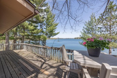 On the shores of beautiful Woman Lake, this home captures the - photo 3