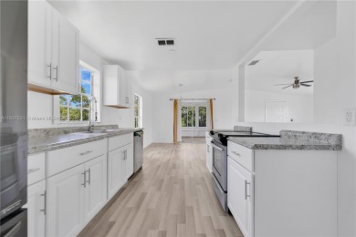 **SHORT SALE!** Light-filled corner home on the Caloosahatchee