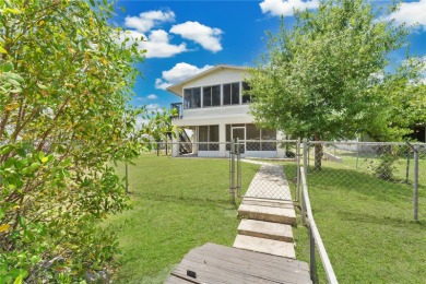 **SHORT SALE!** Light-filled corner home on the Caloosahatchee