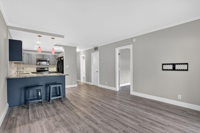 This condominium features an open kitchen, equipped with new - photo 13